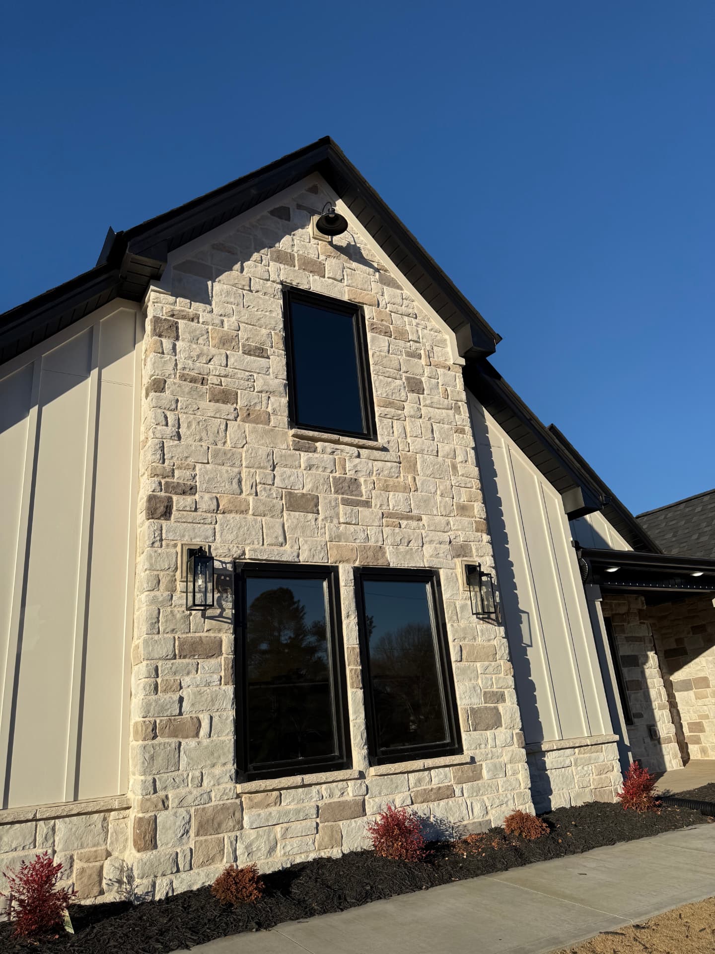 Completed home exterior with dark window film on the front glass