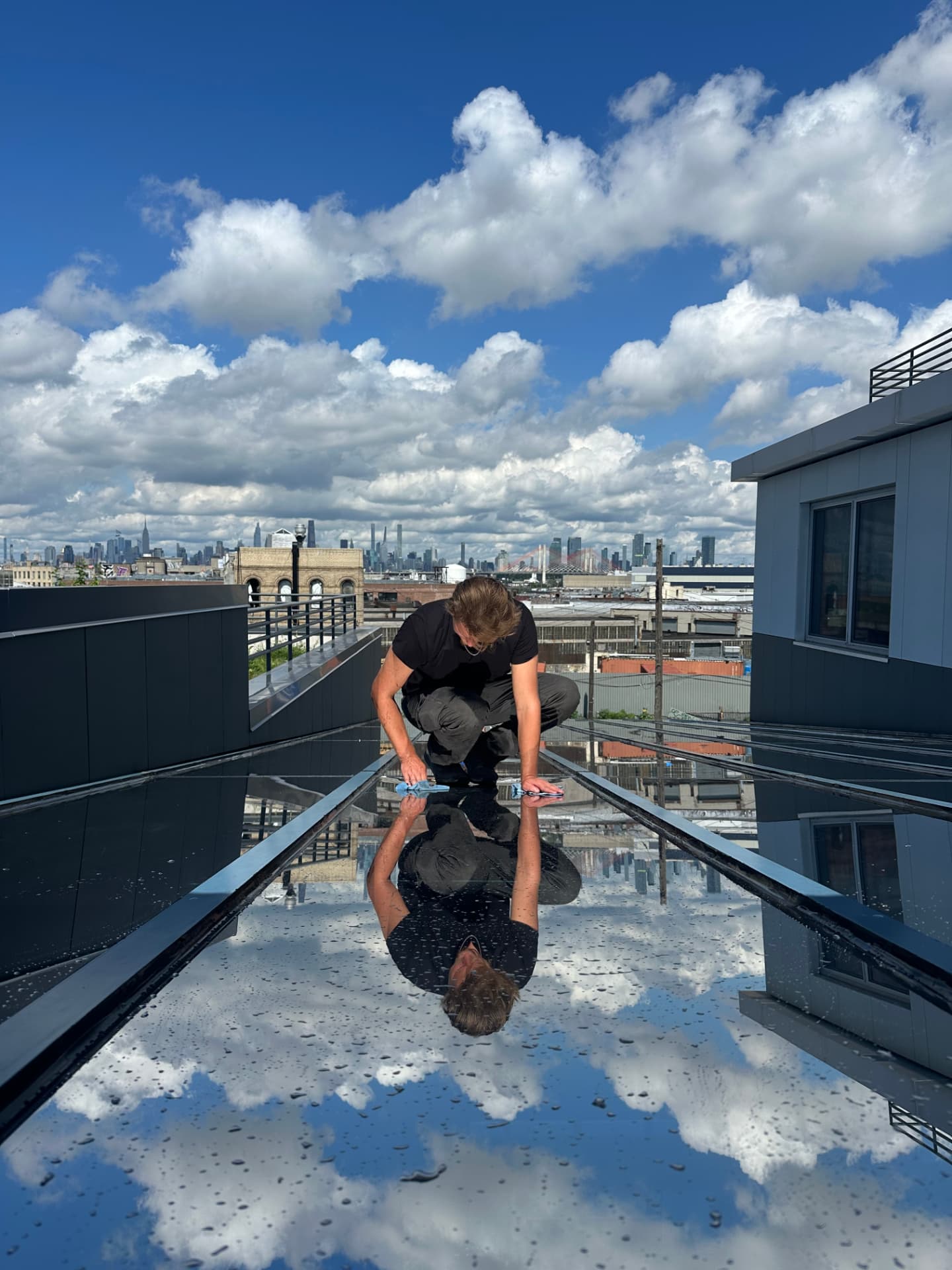 Installer preparing rooftop glazing for a commercial film installation